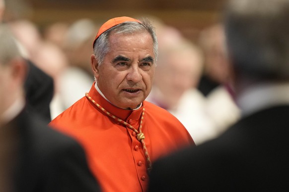 FILE - Cardinal Angelo Becciu attends the consistory inside St. Peter&#039;s Basilica at the Vatican, on Aug. 27, 2022. Lawyers for a once-powerful cardinal accused Vatican prosecutors of being ?priso ...