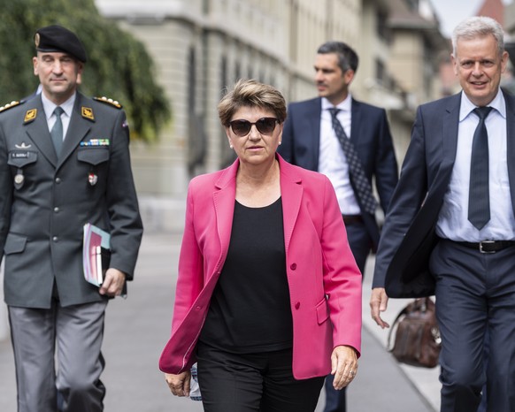 epa09313492 Swiss Federal Councillor Viola Amherd (C) walks with Armed Forces Chief Martin Sonderegger (R), and Armed Forces Chief Thomas Suessli (L) to the media conference to announce the government ...