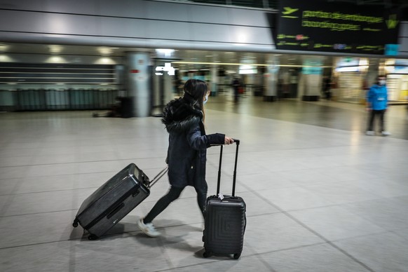 epa08979841 A passenger passes by the departure terminal of Lisbon airport, Lisbon, Portugal, 01 February, 2021. Portugal has extended the restrictive measures concerning air traffic from outside the  ...