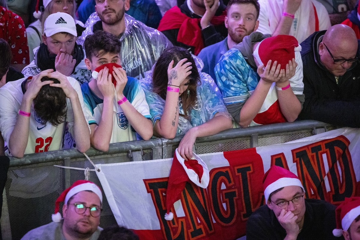 epa10360375 England fans react as they watch the FIFA World Cup 2022 quarter final soccer match between England and France at Boxpark Wembley in London, Britain, 10 December 2022. France won 2-1. EPA/ ...