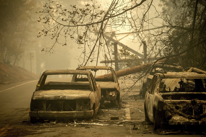 Abandoned cars, scorched by the wildfire, line Pearson Rd. in Paradise, Calif., on Saturday, Nov. 10, 2018. Not much is left in Paradise after a ferocious wildfire roared through the Northern Californ ...