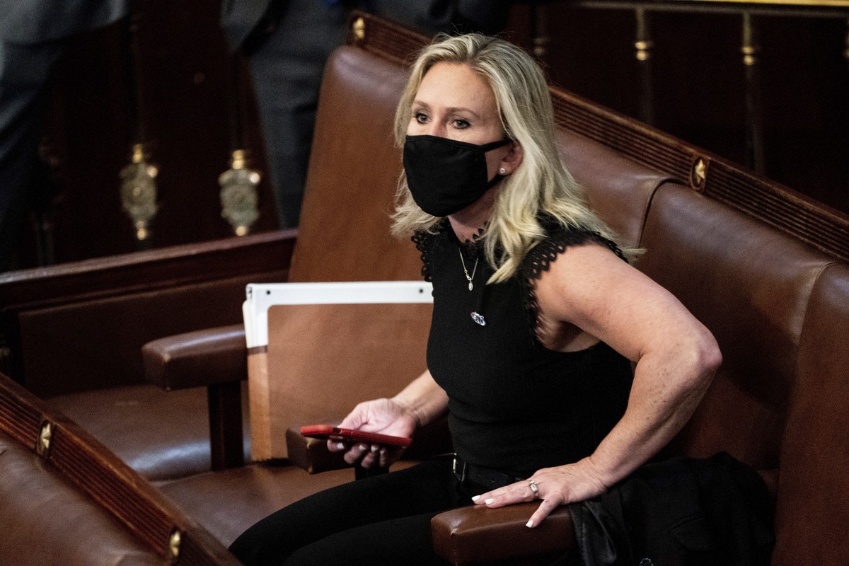 FILE - In this Jan. 6, 2021, file photo, Rep. Marjorie Taylor Greene, R-Ga., sits in the House Chamber after they reconvened for arguments over the objection of certifying Arizona's Electoral Col ...