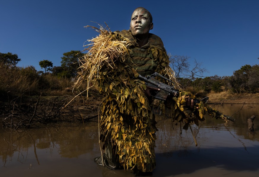 In this image released by the World Press Photo Foundation Thursday April 11, 2019, titled "Akashinga - the Brave Ones" by Brent Stirton, Getty Images, which was awarded first prize in the E ...