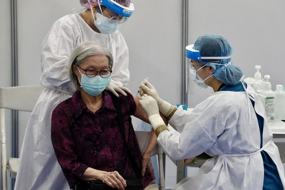 epa09272130 A resident receives a jab of AstraZeneca (Vaxzevria) COVID-19 vaccine during a mass vaccination event in New Taipei city, Taiwan, 15 June 2021. Taiwan started administering the 1.24 millio ...