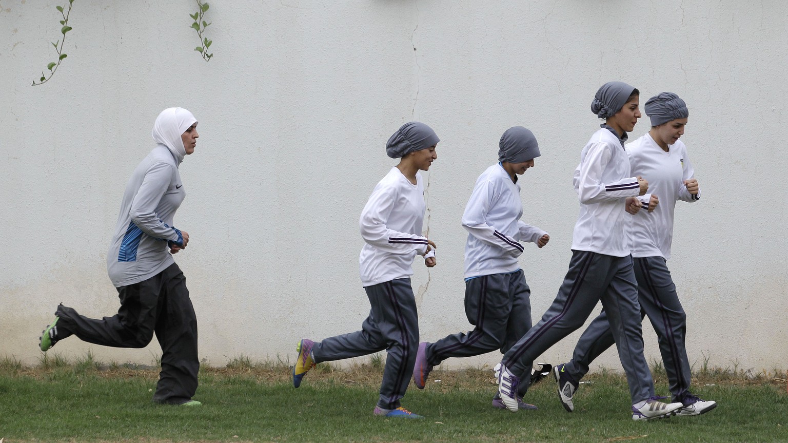 FILE - In this May 21, 2012 file photo, members of a Saudi female soccer team practice at a secret location in Riyadh, Saudi Arabia. Single Saudi women stand at the center of a societal pivot. On the  ...