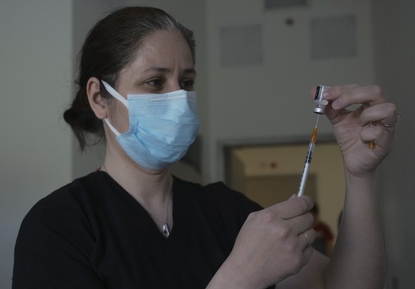 A nurse prepares to administer the second dose of Pfizer COVID-19 vaccine at a hospital, in Ankara, Turkey, Saturday, May 1, 2021. Turkish President Recep Tayyip Erdogan imposed the new lockdown restr ...