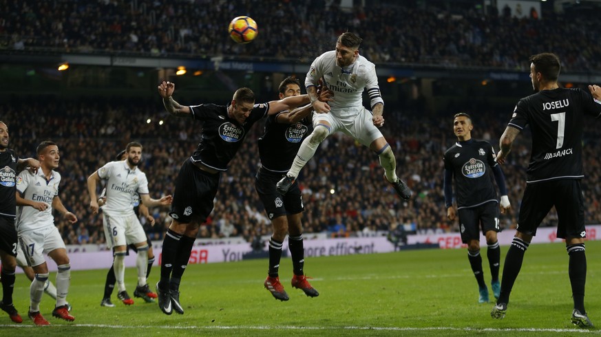 Real Madrid&#039;s Sergio Ramos, top, heads the ball to score the winning goal against Deportivo during a Spanish La Liga soccer match between Real Madrid and Deportivo Coruna at the Santiago Bernabeu ...