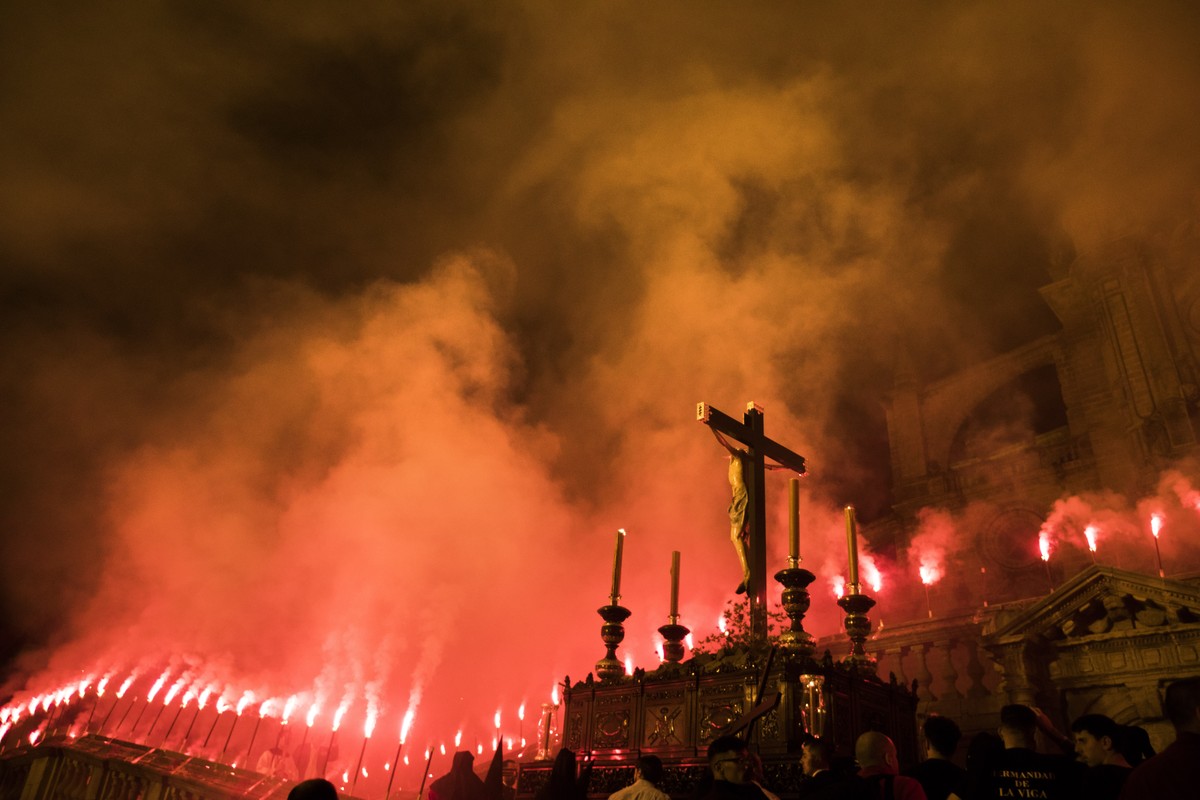 The statue of Christ from "La Viga" brotherhood is carried along a road illuminated with torches during a procession in Jerez de la Frontera, Cadiz province in Andalucia, southern Spain, Mon ...