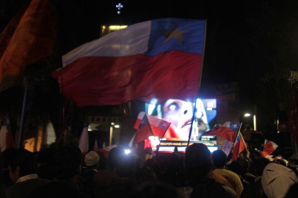 FILE - In this Oct. 12, 2010 file photo, people celebrate while watching on a giant TV screen the first rescuer descend into an escape tunnel at the San Jose mine to begin rescue operations for the 33 ...