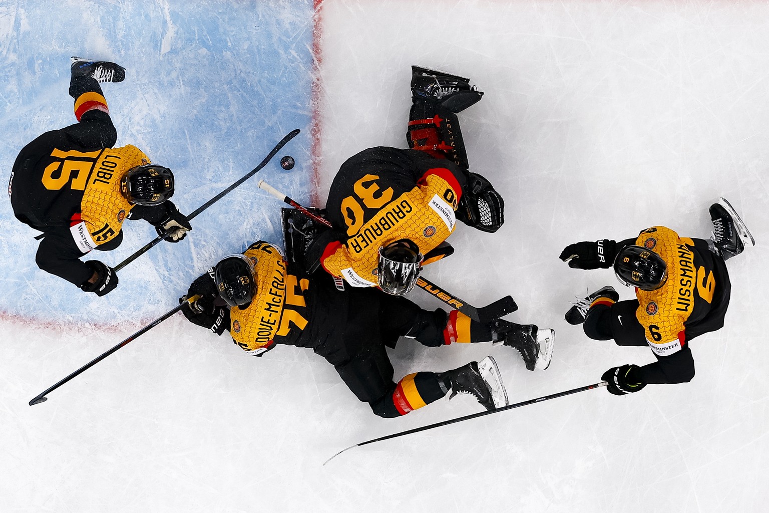 epaselect epa12969178 (L-R) Germany's Stefan Loibl, Samuel Dove-McFalls, goaltender Philipp Grubauer, and Kai Wissmann stop a puck during the 2026 IIHF Men's Ice Hockey World Championship pr ...