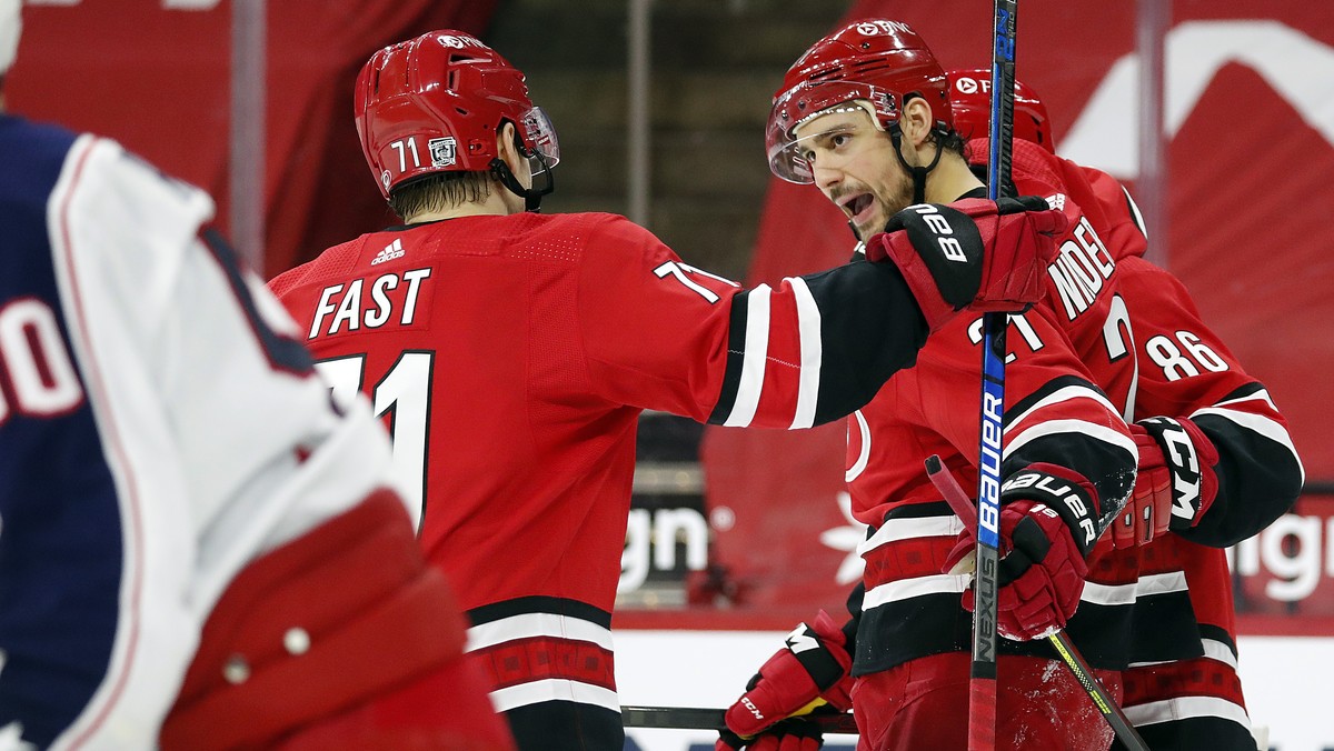 Carolina Hurricanes' Nino Niederreiter (21) celebrates his goal with teammate Teuvo Teravainen (86) and Jesper Fast (71) during the second period of an NHL hockey game against the Columbus Blue J ...