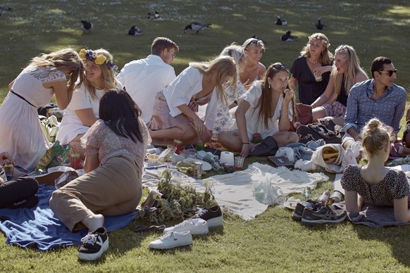 FILE - In this Friday June 19, 2020 file photo people picnic during the annual Midsummer celebrations in Stockholm, Sweden. Sweden's relatively low-key approach to coronavirus lockdowns captured the w ...