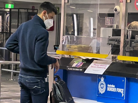 Serbia&#039;s Novak Djokovic, the Australian Open defending champion, waits at an Australian Border Force desk on his arrival at Melbourne Airport, Wednesday, Jan. 5, 2022. Locked in a dispute over hi ...