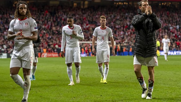 Switzerland&#039;s Kevin Mbabu, Manuel Akanji, Nico Elvedi and Stephan Lichtsteiner, from left, leave the pitch after the UEFA Euro 2020 qualifying Group D soccer match between Denmark and Switzerland ...