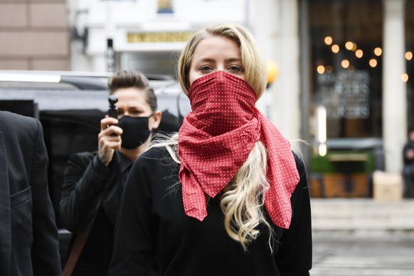 Amber Heard arrives at the High Court in London, Wednesday July 8, 2020. Johnny Depp is facing a second day of cross-examination by lawyers for British tabloid The Sun, which is defending a libel clai ...