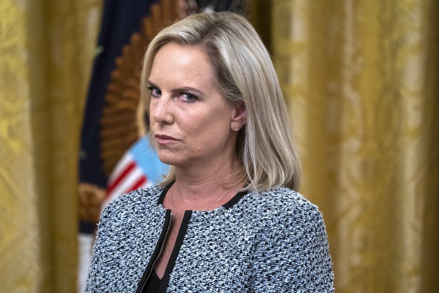 epa07491144 (FILE) US Secretary of Homeland Security Kirstjen Nielsen listens to Vice President Mike Pence speak at an event to honor federal immigration agents in the East Room of the White House in  ...