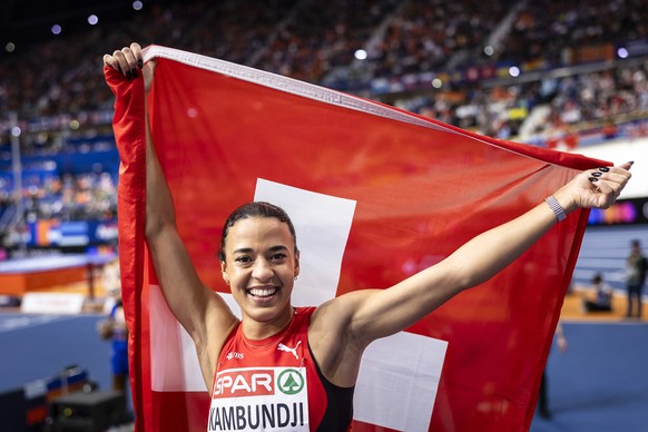 Gold medalist Ditaji Kambundji of Switzerland celebrats with a national flag after winning the 60 meters hurdles final during the European Athletics Indoor Championships at the Omnisport arena in Apel ...