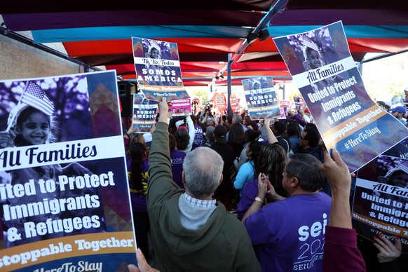 epa05717643 Hundreds of demonstrators protest for immigrant rights and against US President-elect Donald Trump during a rally in downtown Los Angeles, California, USA, 14 January 2017. Trump will take ...