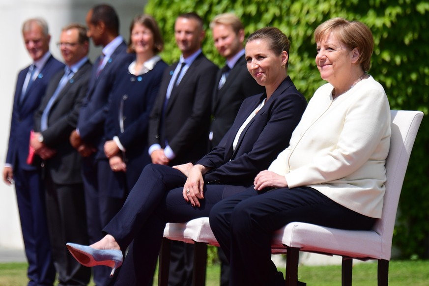 epaselect epa07709520 German Chancellor Angela Merkel (R) and Danish Prime Minister Mette Frederiksen (L) during a reception with military honors at the Chancellery in Berlin, Germany, 11 July 2019. G ...