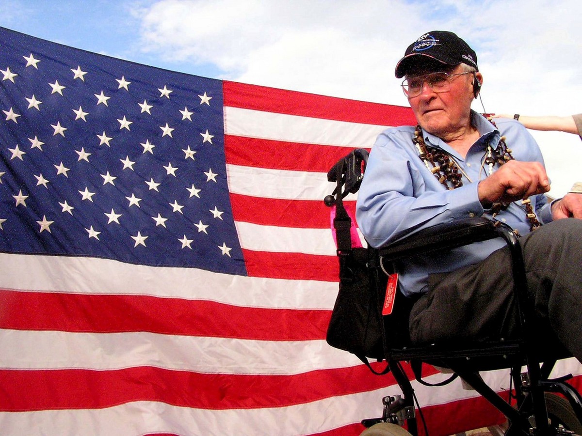 Retired Brig. Gen. Paul W. Tibbets Jr. is seen in front of a U.S. flag draped on the tent covering the bomb pit at North Field on Tinian island, Northern Marianas, USA on Wednesday, 16 June 2004. This ...
