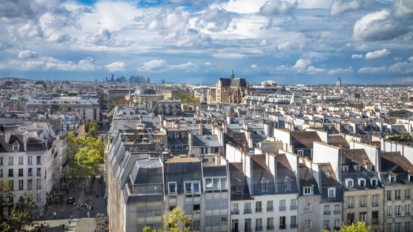 Paris rooftops looking west, France A view over Paris rooftops looking west from the Pompidou Centre towards the Catholic Saint-Eustace Church and in the far distance the high rise buildings of La Def ...