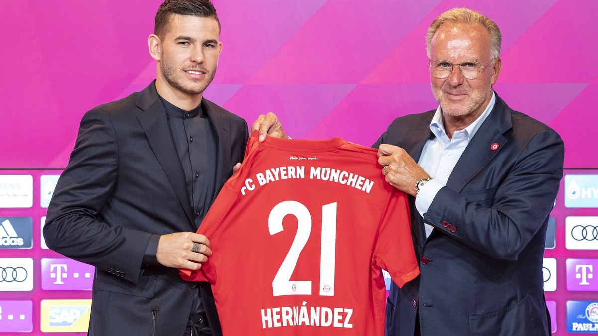 epa07703572 New FC Bayern Munich player Lucas Hernandez (L) and Bayern Munich's chairman of the board Karl-Heinz Rummenigge pose during Hernandez' presentation at the Allianz Arena in Munich ...