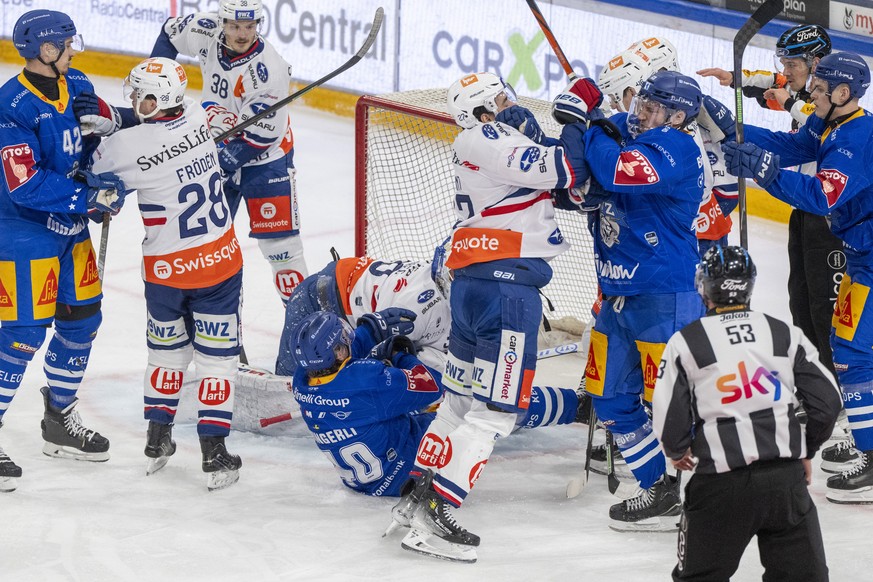 Mike Kuenzle, mitte recuts, von Zug im Kampf gegen Derek Grant, mitte links, vom ZSC beim Eishockey Qualifikationsspiel der National League zwischen dem EV Zug und den ZSC Lions am Samstag, 10. Januar ...