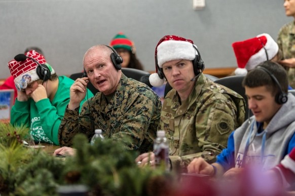 This Dec. 24, 2019 photo provided by The North American Aerospace Defense Command (NORAD) shows members of NORAD tracking Santa team at the NORAD Tracks Santa Operations Center on Peterson Air Force B ...