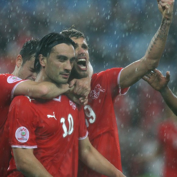 Swiss Tranquillo Barnetta, Hakan Yakin and Valon Behrami (from L) celebrate after Yakin&#039;s 1-0, during the EURO 2008 preliminary round group A match between Switzerland and Turkey at the St. Jakob ...