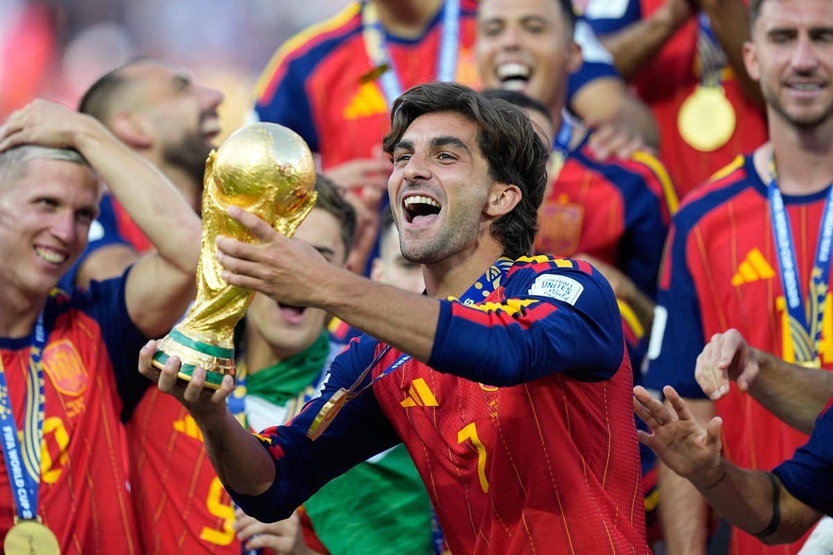 Spain's Ferran Torres celebrates with the trophy after winning the World Cup final soccer match between Spain and Argentina in East Rutherford, N.J., near New York, Sunday, July 19, 2026. (AP Pho ...