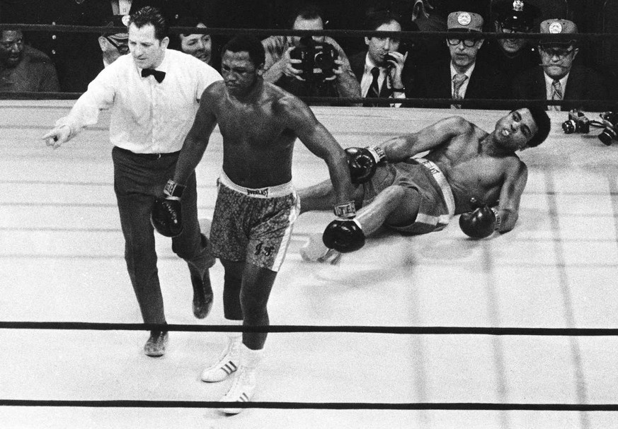 In this March 8, 1971 photo, boxer Joe Frazier is directed to the ropes by referee Arthur Marcante after knocking down Muhammad Ali during the 15th round of the title bout in Madison Square Garden in  ...