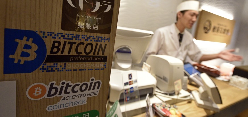 epa06004897 Ken Nagahama, Numazuko Ginza sushi restaurant manager, demonstrates the Bitcoin payment system at his restaurant in central Tokyo, Japan, 01 June 2017 (issued 02 June 2017). Bitcoin usage  ...