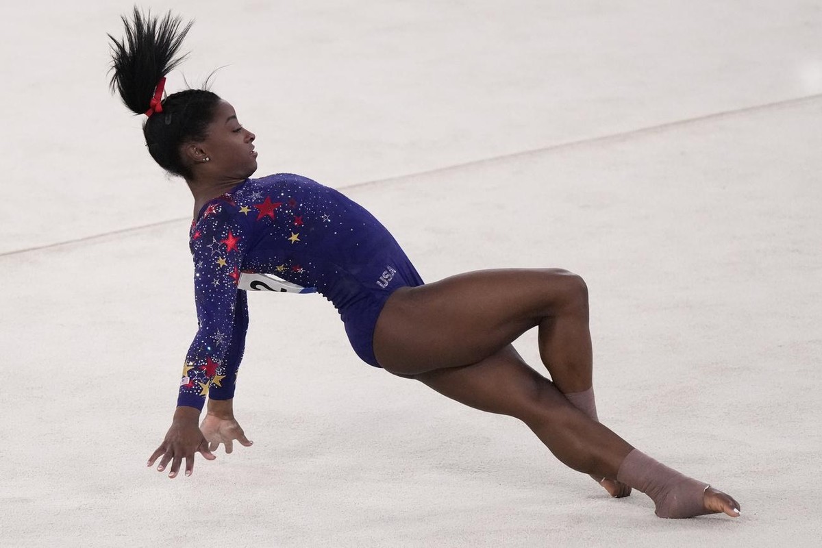 Simone Biles, of the United States, performs her floor exercise routine during the women's artistic gymnastic qualifications at the 2020 Summer Olympics, Sunday, July 25, 2021, in Tokyo. (AP Phot ...