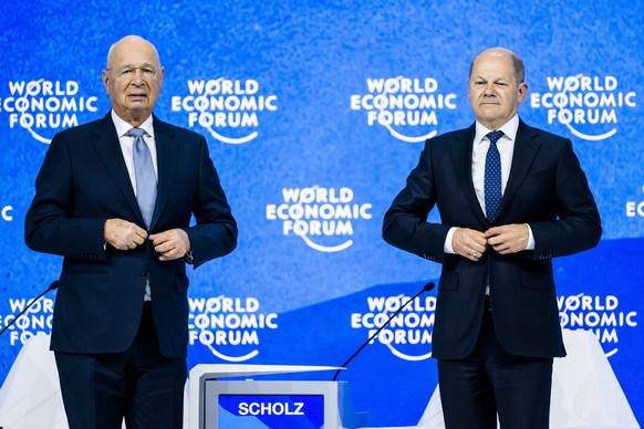 epa09976668 Klaus Schwab (L), Founder and Executive Chairman of the World Economic Forum, and German Chancellor Olaf Scholz (R) attend the 51st annual meeting of the World Economic Forum (WEF) in Davo ...