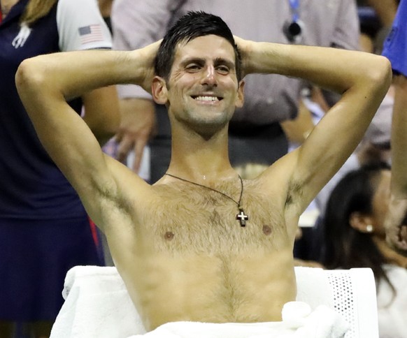 epa07000080 Novak Djokovic of the Serbia reacts during a heat break during his match against John Millman of Australia during their quarter-final match on the tenth day of the US Open Tennis Champions ...