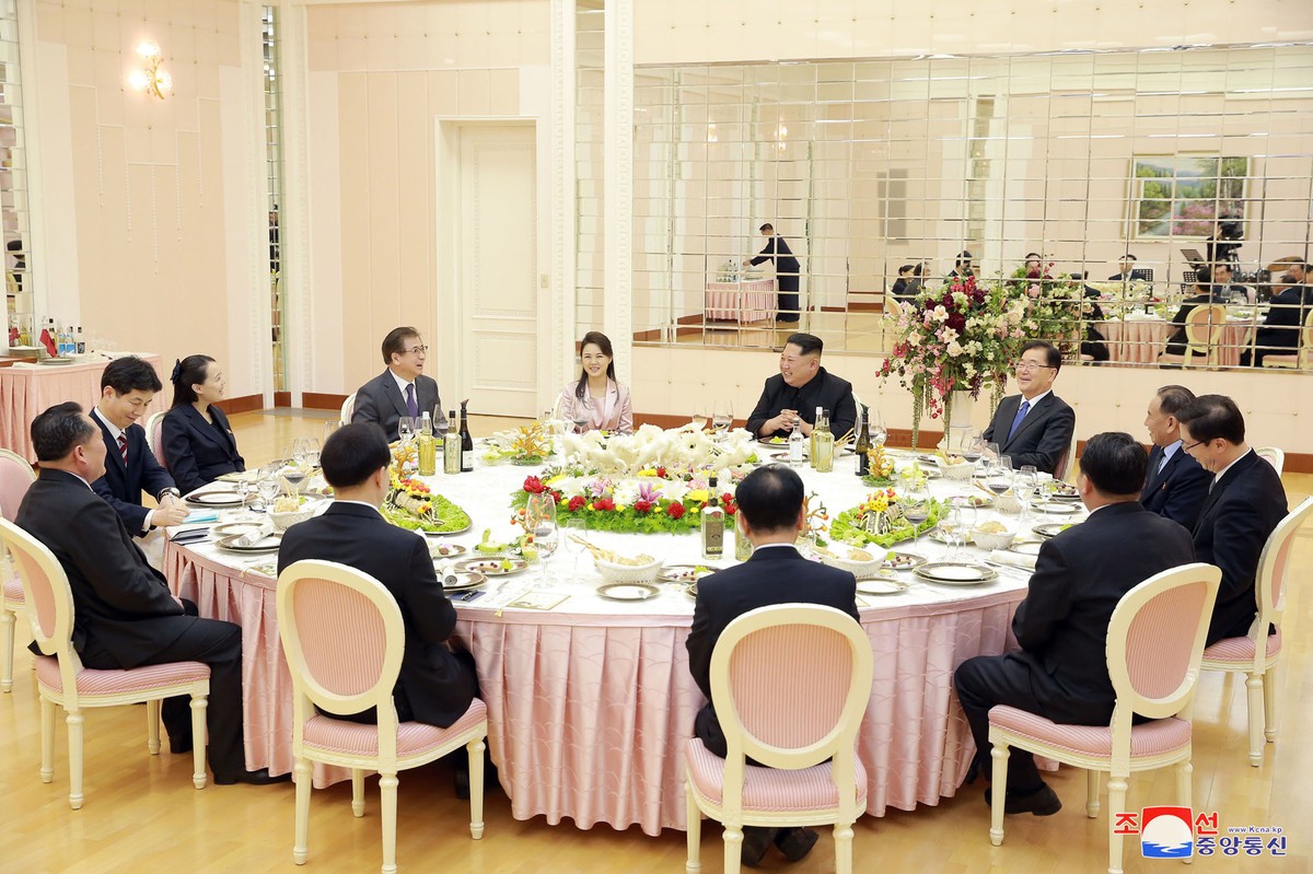 In this Monday, March 5, 2018 photo, provided by the North Korean government on March 6, North Korean leader Kim Jong Un, center right in the background, and his wife Ri Sol Ju, center left in the bac ...