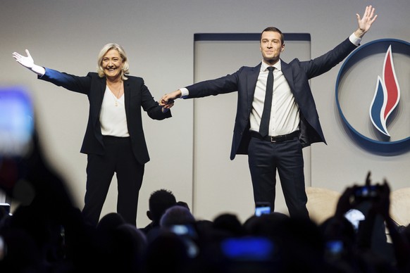 FILE - French far right leader Marine Le Pen celebrates with newly elected chief of the National Rally president Jordan Bardella during the party congress in Paris, Saturday, Nov.5, 2022. Jordan Barde ...