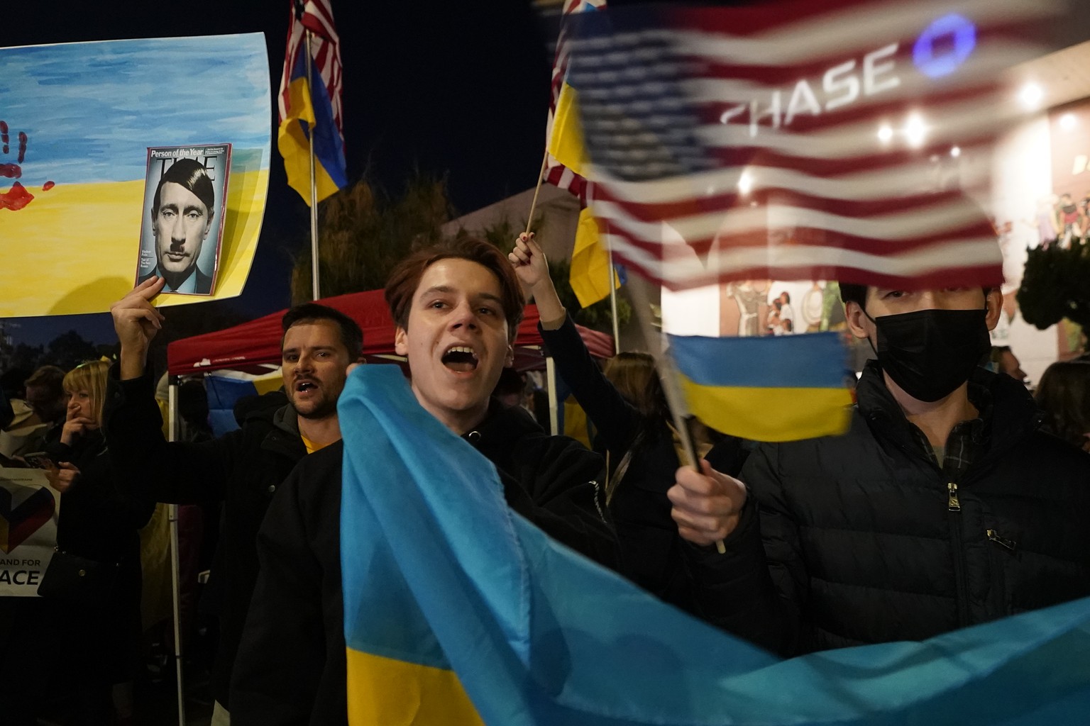 People protest the Russian invasion of Ukraine at a demonstration in the Studio City neighborhood of Los Angeles, Thursday, Feb. 24, 2022. (AP Photo/Damian Dovarganes)