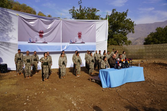 FILE - Kurdistan Workers' Party (PKK) fighters, who reportedly withdrew from Turkey with their weapons, stand to attention during a ceremony in the Qandil area of northern Iraq, ?? Oct 26, 2025.  ...