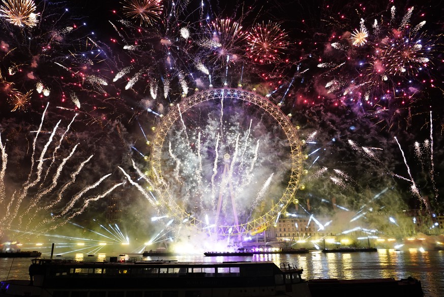 Fireworks light-up the sky over the London Eye in central London to celebrate the New Year on Sunday, Jan. 1, 2023 (AP Photo/Alberto Pezzali)