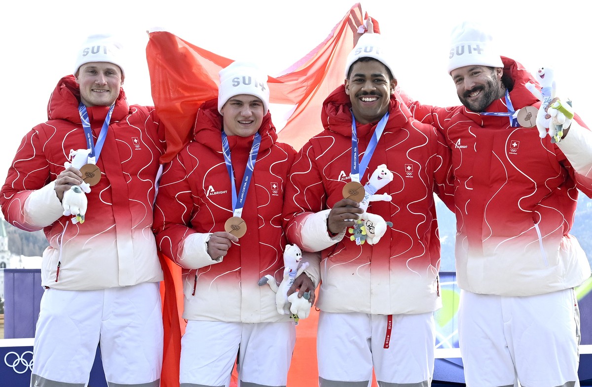 epa12768209 Bronze medalists Michael Vogt, Andreas Haas, Amadou David Ndiaye, and Mario Aeberhard of Switzerland during the medal ceremony for the 4-Man of the Bobsleigh competitions at the Milano Cor ...