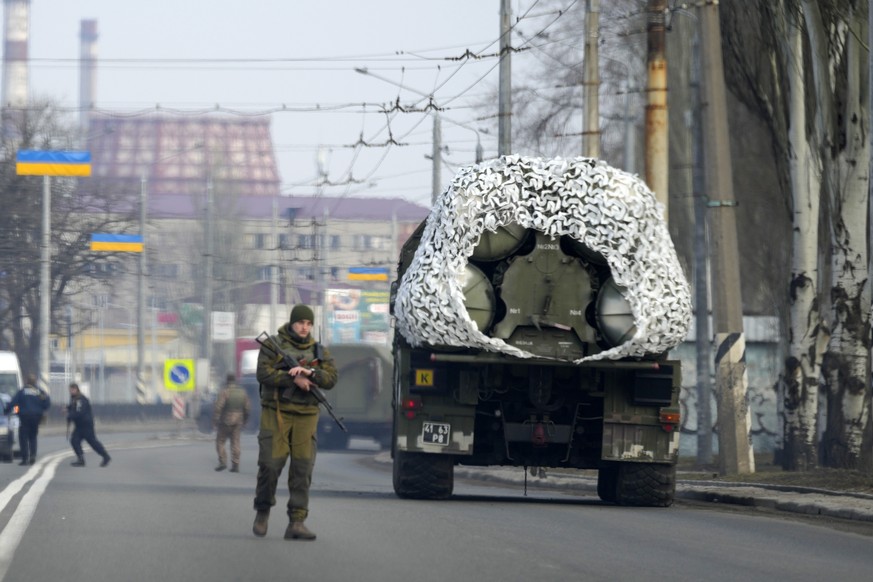 A Ukrainian soldier stands next to a military vehicle on a road in Kramatosrk, eastern Ukraine, Thursday, Feb. 24, 2022. Russian troops launched a wide-ranging attack on Ukraine on Thursday. President ...