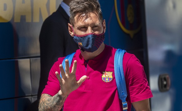 FILE - In this Aug. 13, 2020 file photo, Barcelona's Lionel Messi waves as he arrives at the team hotel in Lisbon, Portugal. Lionel Messi has told Barcelona he wants to leave the club after nearly two ...