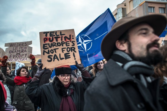 epa06393748 Demonstrators carry a banner &#039;Tell Putin Europe is not for Sale&#039; as they protest against a conference of European right-wing party ENF, Europe Nations and Freedom, in Prague, Cze ...