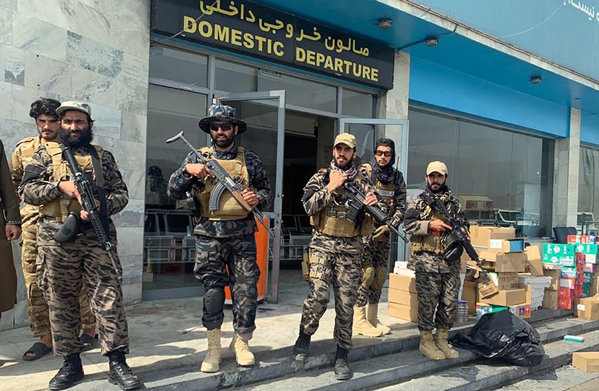 Taliban fighters stand guard inside the Hamid Karzai International Airport after the U.S. withdrawal in Kabul, Afghanistan, Tuesday, Aug. 31, 2021. The Taliban were in full control of Kabul&#039;s int ...