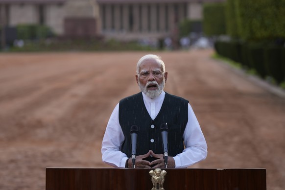 Indian Prime Minister Narendra Modi speaks to the media at the forecourt of the Indian presidential palace after receiving a letter from the President of India, Droupadi Murmu, inviting him to form th ...