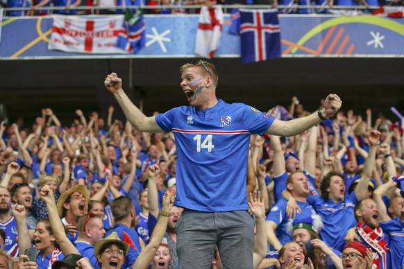 Iceland&#039;s supporters celebrate during the Euro 2016 round of 16 soccer match between England and Iceland, at the Allianz Riviera stadium in Nice, France, Monday, June 27, 2016. (AP Photo/Pavel Go ...