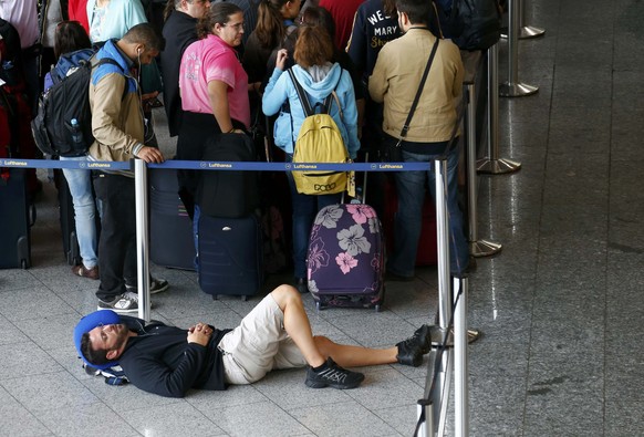 Ein Passagier ruht sich vor einem Check-in-Desk aus – 166'000 Passagiere sind nach Angaben des Unternehmens von dem Streik betroffen.