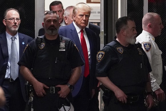 Former President Donald Trump will be escorted to a courtroom in New York on Tuesday, April 4, 2023.  Trump will appear in a New York City courtroom on charges of falsifying business documents in…