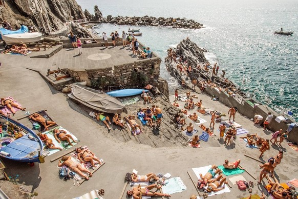 PICTURES: Winning shots of Humans of The World competition revealed judged by British photographer Martin Parr Story from Jam Press Life Framer Awards Pictured - Manarola Sunbathers, Italy by David Ab ...